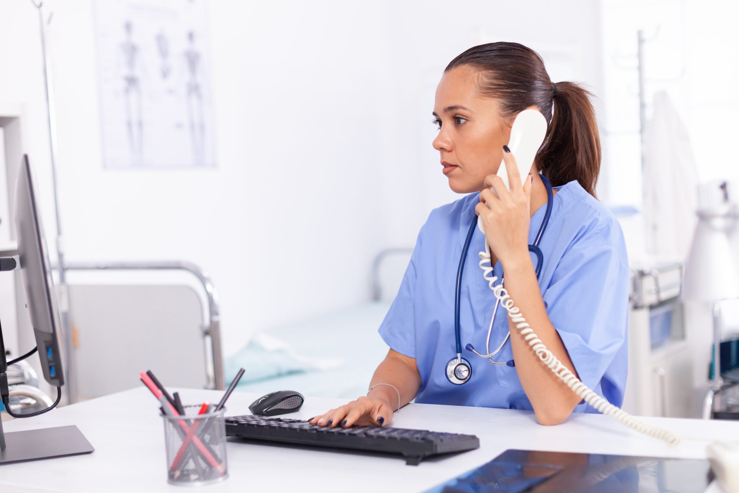 https://alpharadiology.com.au/wp-content/uploads/2023/08/medical-nurse-talking-with-patient-phone-about-diagnosis-health-care-physician-sitting-desk-using-computer-modern-clinic-looking-monitor-scaled.jpg